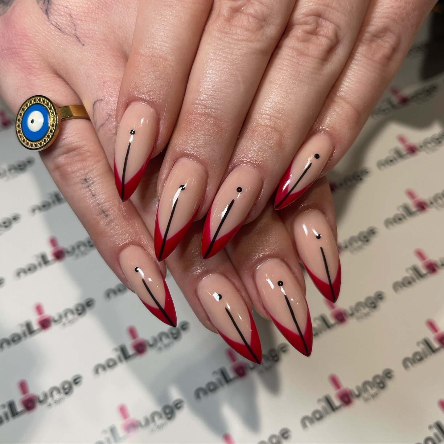 Stiletto Acrylic Extensions with red French finish and nail art at Nail Lounge & Spa Brighton